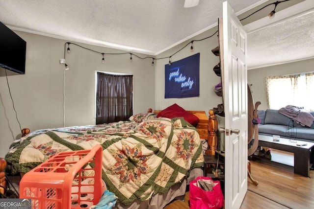 bedroom with hardwood / wood-style floors and a textured ceiling