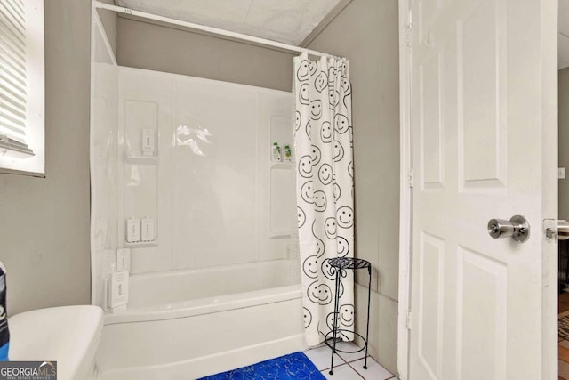 bathroom featuring shower / tub combo with curtain and tile patterned flooring