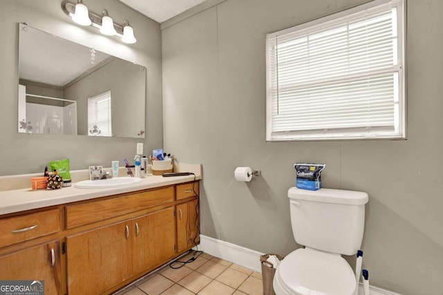 bathroom with tile patterned flooring, vanity, and toilet