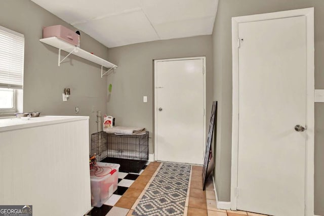 laundry room with light tile patterned floors