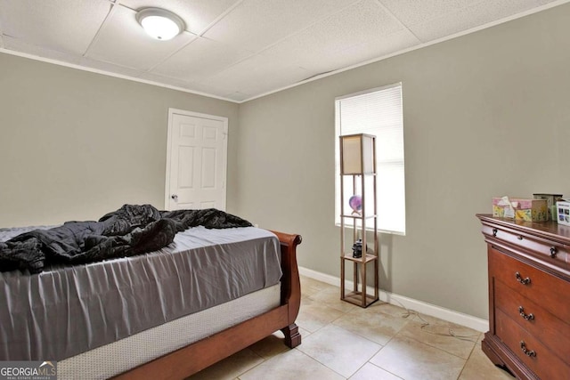 tiled bedroom featuring ornamental molding