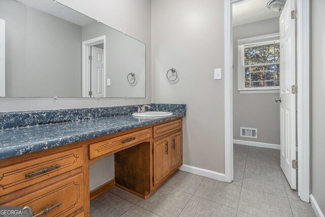 bathroom featuring tile patterned flooring and vanity