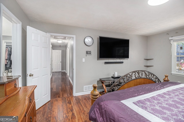 bedroom with dark hardwood / wood-style flooring