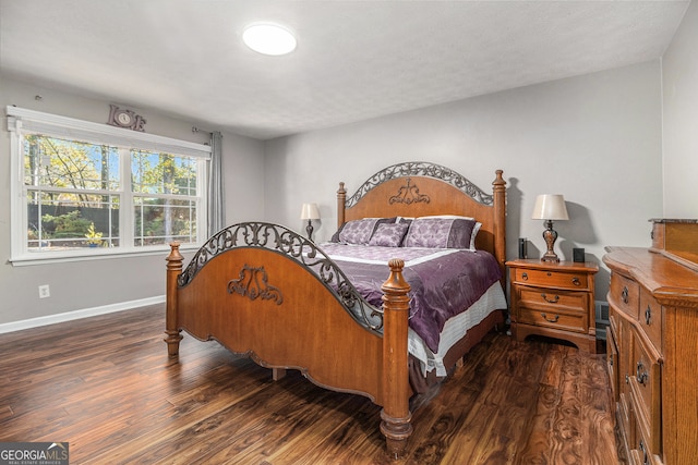 bedroom with dark wood-type flooring and a textured ceiling