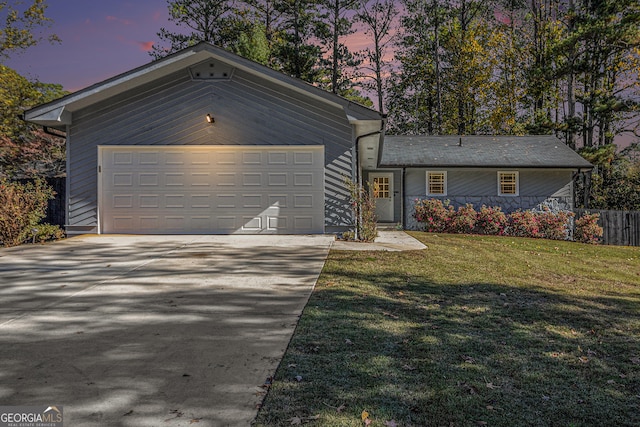 view of front of property with a yard and a garage