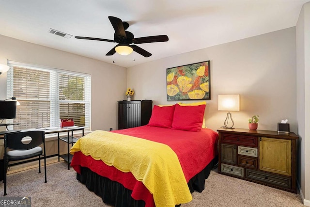 bedroom with ceiling fan and light carpet