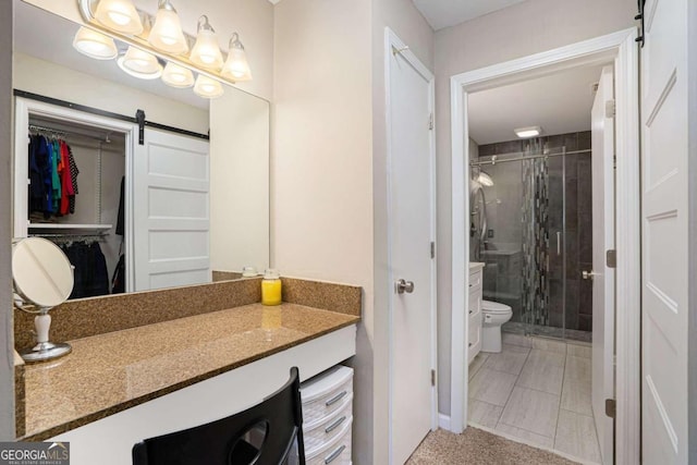 bathroom with vanity, toilet, and a shower with door