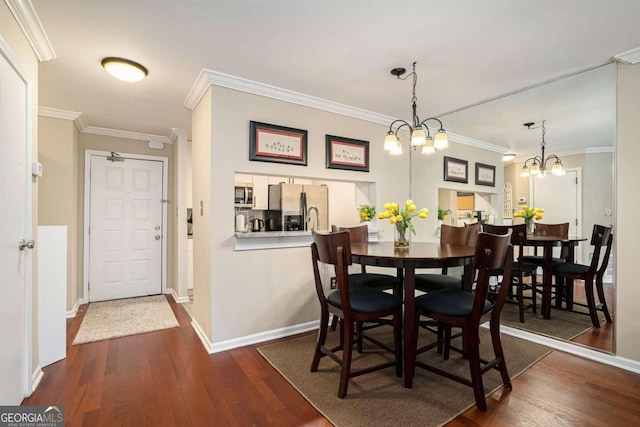 dining area with crown molding, a chandelier, and dark hardwood / wood-style floors