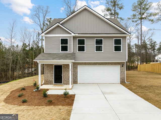 view of front facade with a garage and a front lawn