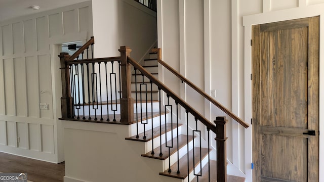 staircase with hardwood / wood-style flooring