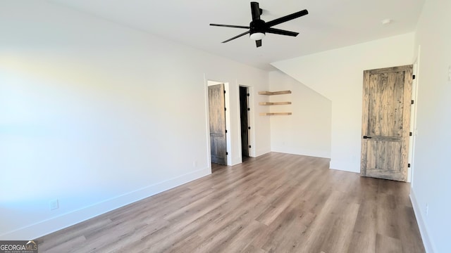 empty room with ceiling fan and light wood-type flooring