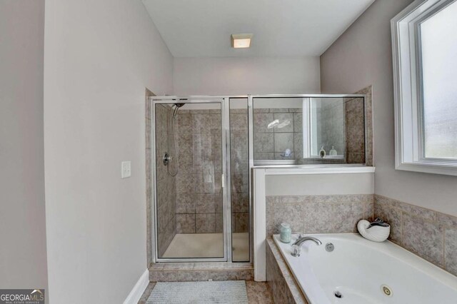 bathroom featuring tile patterned floors and independent shower and bath