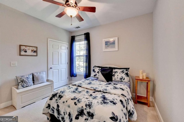 bedroom with ceiling fan and light colored carpet