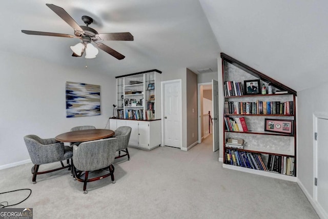 dining space with lofted ceiling, light carpet, and ceiling fan