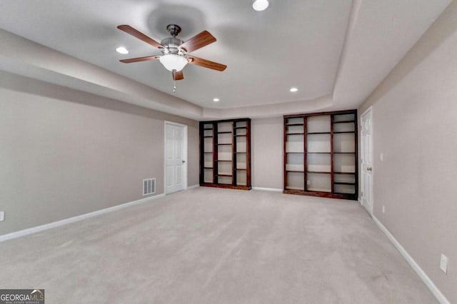 carpeted spare room with ceiling fan