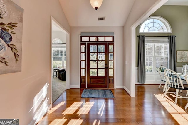 entryway featuring dark wood-type flooring and lofted ceiling