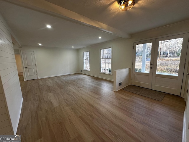 foyer entrance with beam ceiling, french doors, recessed lighting, wood finished floors, and baseboards