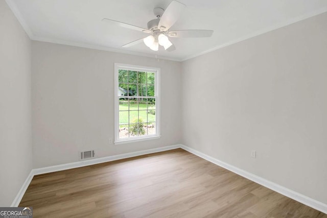 unfurnished room featuring ceiling fan, ornamental molding, and light hardwood / wood-style floors