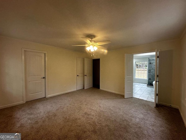 empty room with ceiling fan and light colored carpet