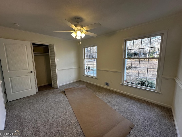 unfurnished bedroom featuring baseboards, carpet, visible vents, and a closet