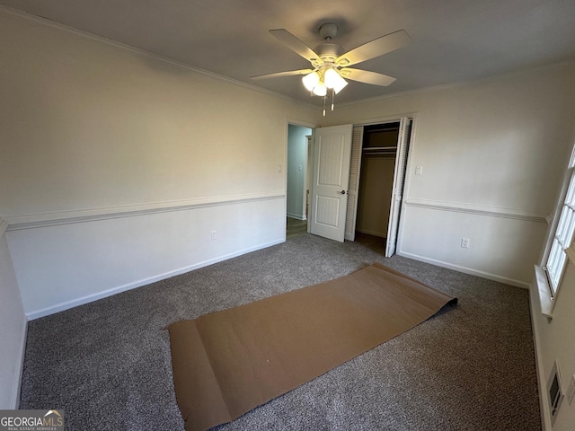 unfurnished bedroom with carpet flooring, crown molding, and visible vents