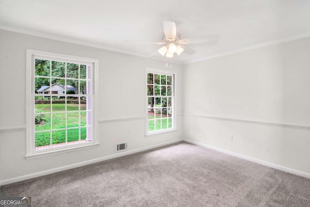 carpeted spare room with ceiling fan and ornamental molding