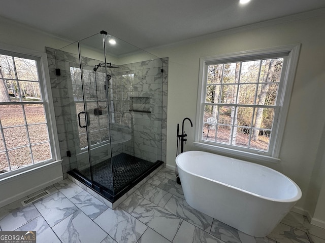 full bath featuring marble finish floor, visible vents, a wealth of natural light, and crown molding