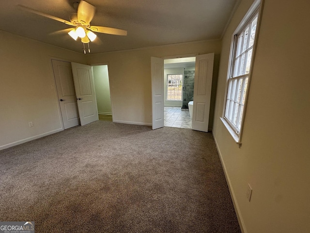 spare room featuring ceiling fan, ornamental molding, and carpet flooring