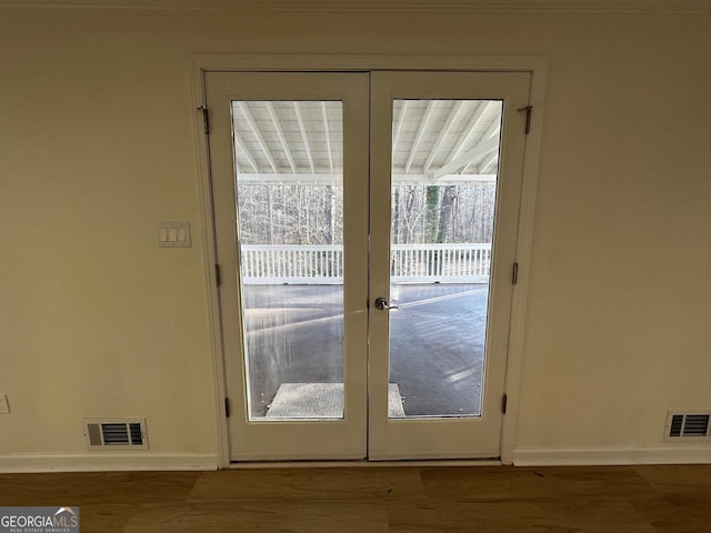 entryway with french doors, wood finished floors, visible vents, and baseboards