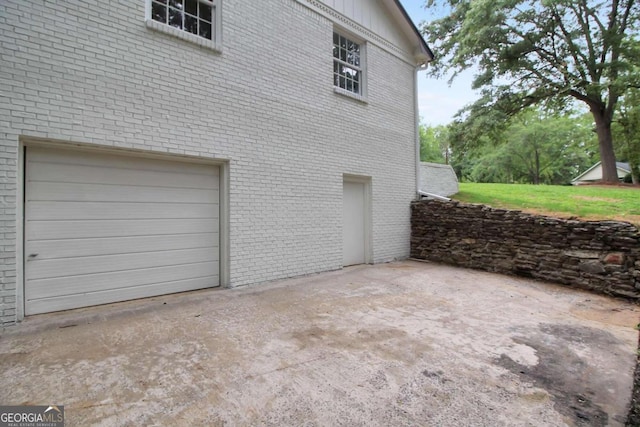 view of side of home featuring a garage