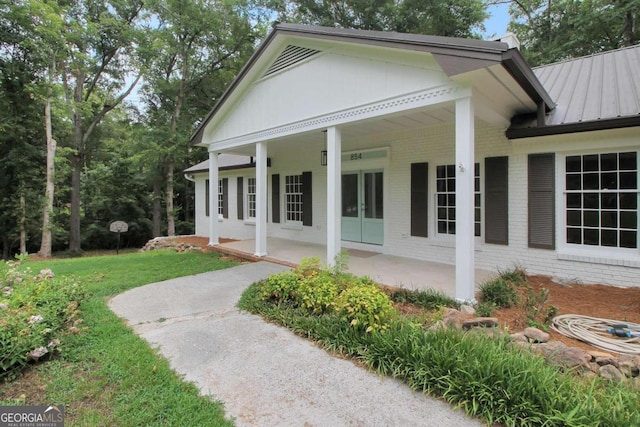 view of home's exterior with a lawn and a patio