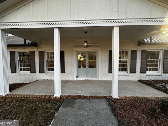 doorway to property with french doors and brick siding