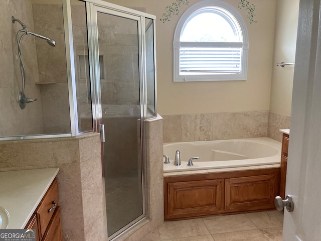 bathroom featuring tile patterned flooring, vanity, and separate shower and tub