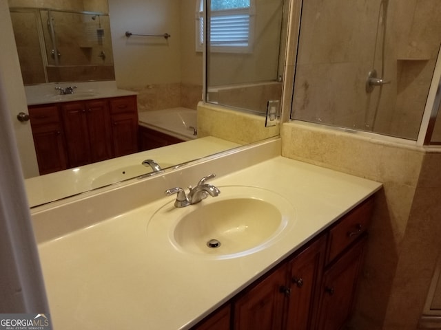 bathroom featuring a washtub and vanity