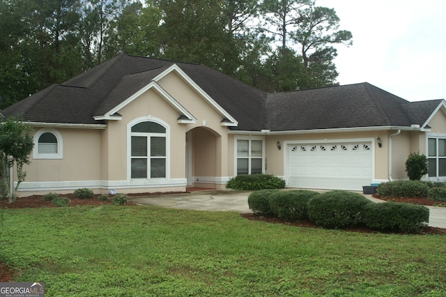 ranch-style home with a garage and a front lawn