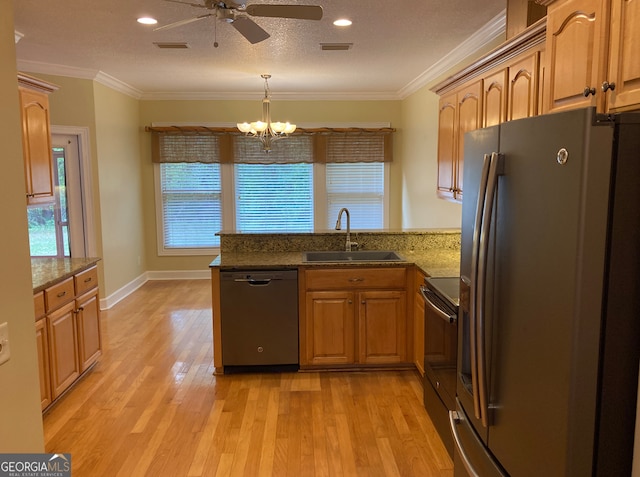 kitchen featuring sink, light hardwood / wood-style flooring, ornamental molding, kitchen peninsula, and stainless steel appliances