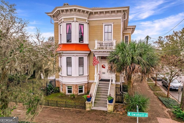 italianate home featuring a balcony