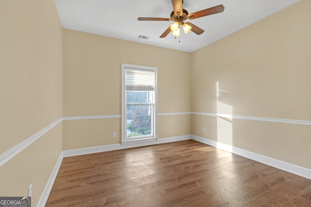 unfurnished room with ceiling fan and hardwood / wood-style flooring