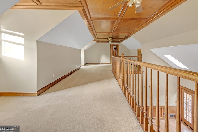 bonus room with light carpet, lofted ceiling with skylight, ceiling fan, and wood ceiling