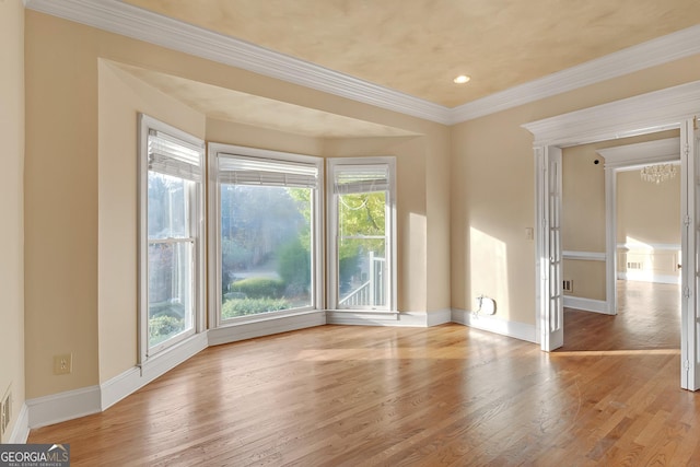 spare room featuring recessed lighting, wood finished floors, visible vents, baseboards, and crown molding