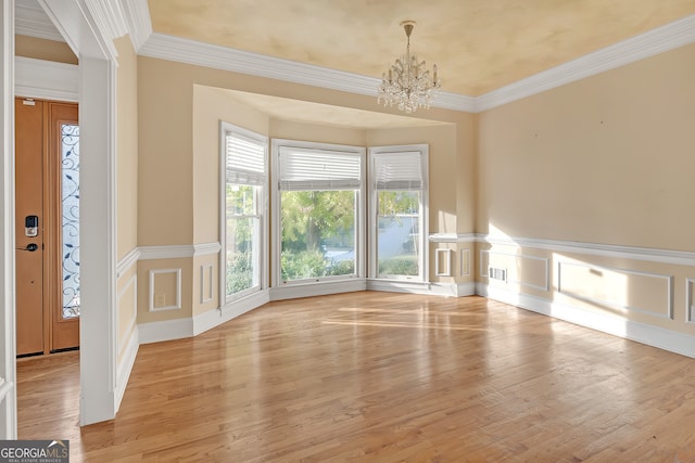 unfurnished living room featuring plenty of natural light, crown molding, and light hardwood / wood-style flooring