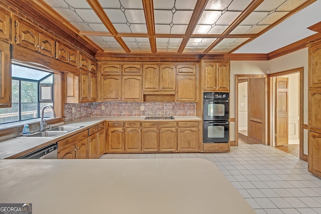 kitchen featuring tasteful backsplash, light countertops, a sink, coffered ceiling, and black appliances