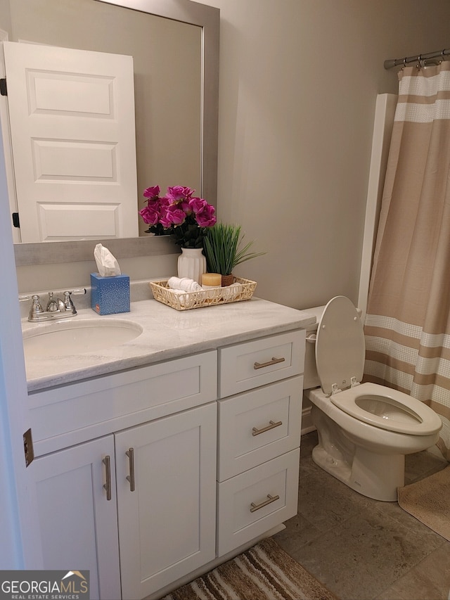 bathroom featuring vanity and toilet