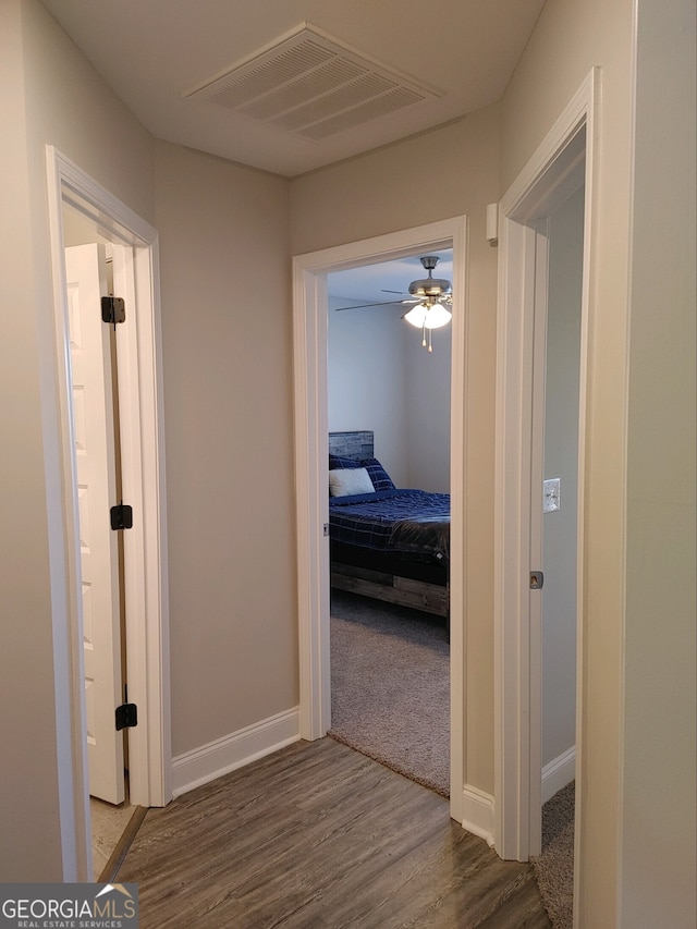 corridor featuring dark hardwood / wood-style flooring