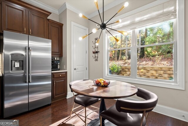 kitchen with high end fridge, dark hardwood / wood-style flooring, crown molding, and a chandelier