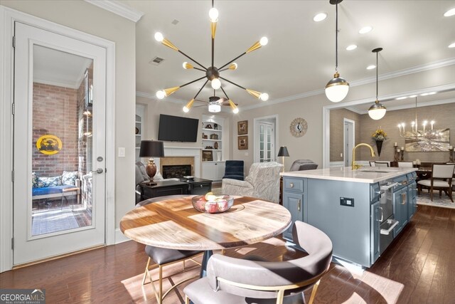 dining area with built in shelves, dark hardwood / wood-style floors, an inviting chandelier, and ornamental molding