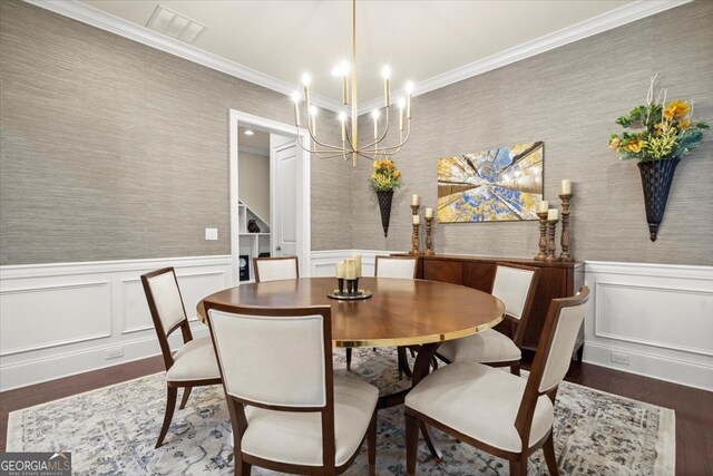 dining room with a notable chandelier, crown molding, and dark wood-type flooring