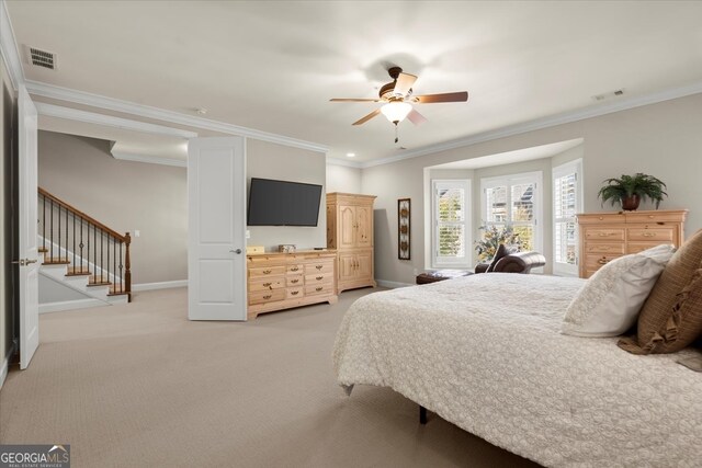 bedroom featuring light carpet, ceiling fan, and crown molding