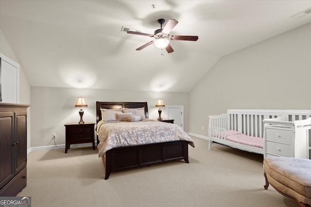 bedroom with ceiling fan, light carpet, and vaulted ceiling