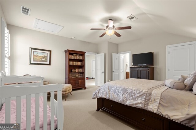 bedroom with ceiling fan, light colored carpet, and vaulted ceiling